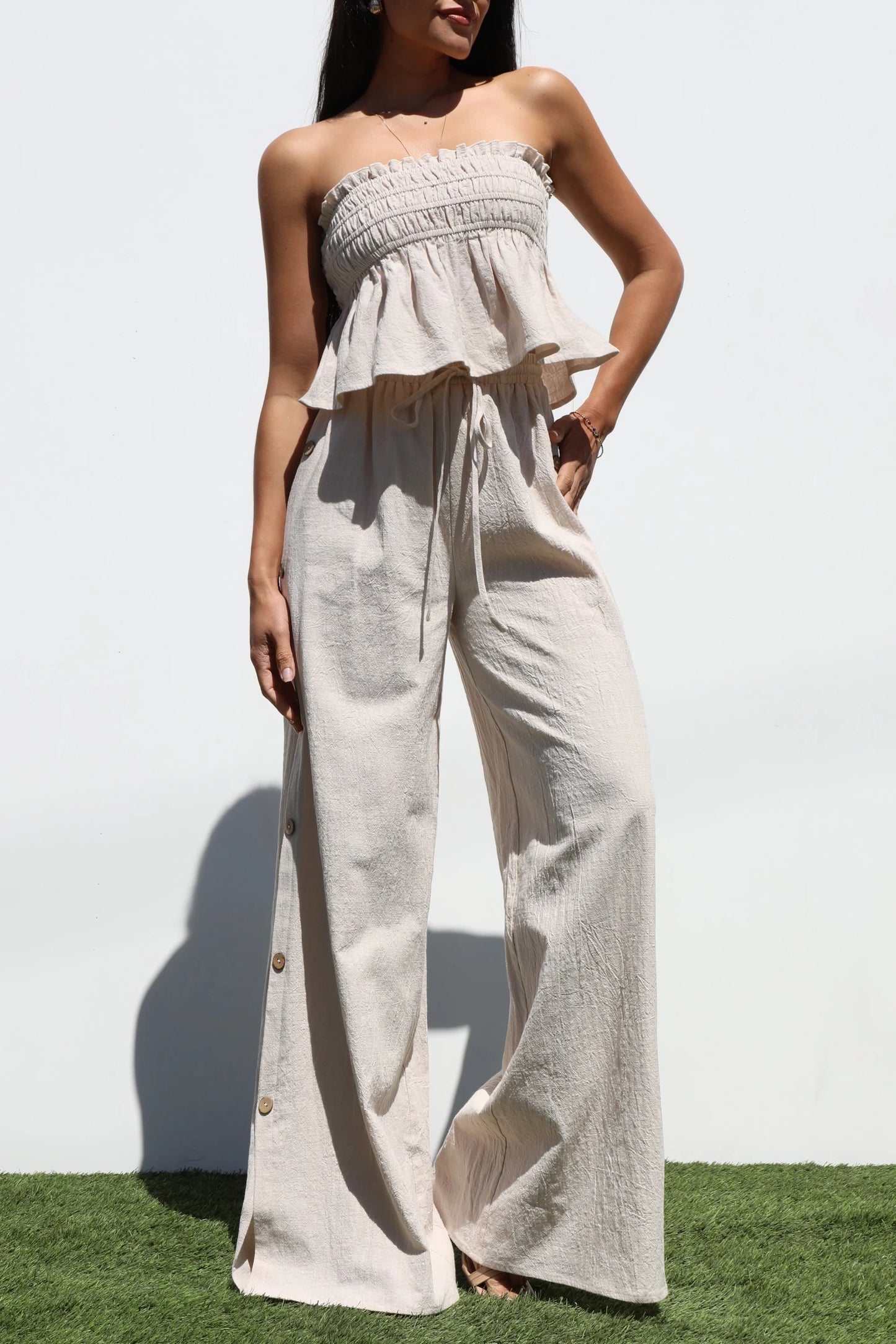 Strapless top and long oatmeal-colored pants set
