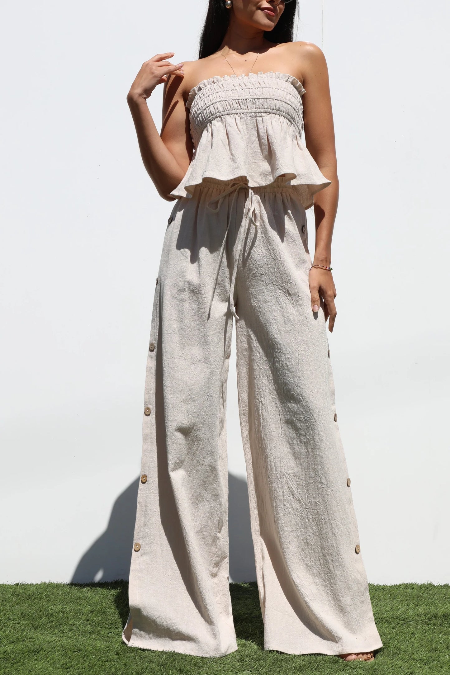 Strapless top and long oatmeal-colored pants set